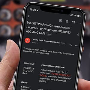 Closeup of a mobile phone showing an email temperature alert